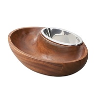With its mood of counterpoint and connection, the Dharma Chip and Dip bowl adds a reflective beauty to the pleasures of snacking. Beautifully balanced, the piece combines a sensuous wooden bowl for chips or crudités with a gleaming inset alloy vessel for fresh salsa or aioli. The mix of materials is arresting yet harmonious, and the nesting oval silhouettes add to the design's flowing appeal. Intelligent craftsmanship makes the piece easy to use and clean, and its tilted axis creates beautiful presentation. An excellent gift for an entertainer, it coordinates seamlessly with Dharma bowls and trays or makes a stunning addition to an eclectic collection. With its mood of counterpoint and connection, the Dharma Chip and Dip bowl adds a reflective beauty to the pleasures of snacking. Beautifully balanced, the piece combines a sensuous wooden bowl for chips or crudités with a gleaming inset alloy vessel for fresh salsa or aioli. The mix of materials is arresting yet harmonious, and the nesting oval silhouettes add to the design's flowing appeal. Intelligent craftsmanship makes the piece easy to use and clean, and its tilted axis creates beautiful presentation. An excellent gift for an entertainer, it coordinates seamlessly with Dharma bowls and trays or makes a stunning addition to an eclectic collection.