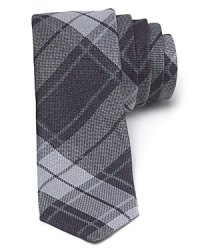 A tonal check pattern offers a classic design in a modern skinny shape for an overall super-cool tie from John Varvatos Star USA. A tonal check pattern offers a classic design in a modern skinny shape for an overall super-cool tie from John Varvatos Star USA.