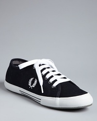 A classic sneaker design from Fred Perry grounds your look in casual coolness. A classic sneaker design from Fred Perry grounds your look in casual coolness.