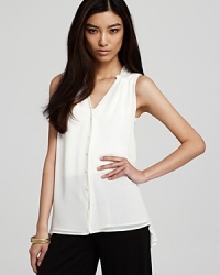 Take a break from the tee and work luxury into your repertoire with this Aqua chiffon blouse, rendered in a loose-fitting silhouette with a polished pleat at the back. Take a break from the tee and work luxury into your repertoire with this Aqua chiffon blouse, rendered in a loose-fitting silhouette with a polished pleat at the back.