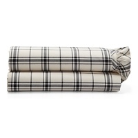 Dramatic black-and-cream checked sheets and pillowcases are edged in feminine pleated ruffles. Dramatic black-and-cream checked sheets and pillowcases are edged in feminine pleated ruffles.