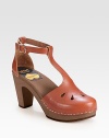 Hand-made and artfully crafted, channel '70s vibes with this leather t-strap with an adjustable ankle strap and wooden heel. Wooden heel, 3½ (90mm)Wooden platform, 1 (25mm)Compares to a 2½ heel (65mm)Leather upperWooden liningRubber soleMade in ItalyOUR FIT MODEL RECOMMENDS ordering true whole size; ½ sizes should order the next whole size up. 