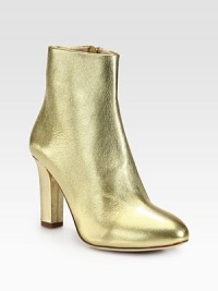 Create a lasting impression with this shimmering metallic leather design hitting just above the ankle. Self-covered heel, 3½ (90mm)Metallic leather upperSide zipLeather liningRubber and leather solePadded insoleMade in Italy