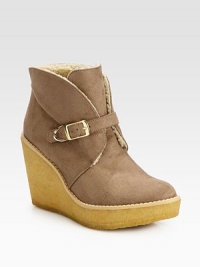 Casual faux suede essential with an adjustable buckle strap, mock shearling lining and elevated rubber wedge. Rubber heel, 3¾ (95mm)Rubber platform, 1¼ (30mm)Compares to a 2½ heel (65mm)Faux suede upperAdjustable buckle strapFaux shearling liningRubber solePadded insoleImported Casual faux suede essential with an adjustable buckle strap, mock shearling lining and elevated rubber wedge. Rubber heel, 3¾ (95mm)Rubber platform, 1¼ (30mm)Compares to a 2½ heel (65mm)Faux suede upperAdjustable buckle strapFaux shearling liningRubber solePadded insoleImported
