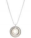 Round and resplendent. This necklace from Nine West is crafted from silver-tone mixed metal, with a pendant made of the same-plus gold-tone and hematite-tone mixed metal-for a stunning effect. Approximate length: 16 inches + 2-inch extender. Approximate drop: 2 inches. Approximate diameter: 1-7/8 inches.