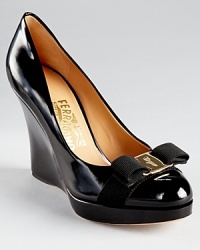 Salvatore Ferragamo showcases classic luxe with the Tosca platforms, a sleek style in patent leather atop a tall wedge. Salvatore Ferragamo showcases classic luxe with the Tosca platforms, a sleek style in patent leather atop a tall wedge.