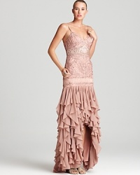 A dramatic, ruffled hem makes a grand entrance on this beaded Sue Wong gown, detailed with intricate beading. A dramatic, ruffled hem makes a grand entrance on this beaded Sue Wong gown, detailed with intricate beading.