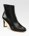 A sleek and sexy design of fine Italian leather with an unexpected goldtone heel. Stacked and lacquered heel, 2¾ (70mm)Leather upperSide zipLeather lining and solePadded insoleMade in ItalyOUR FIT MODEL RECOMMENDS ordering one half size up as this style runs small. 