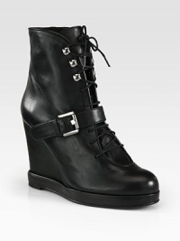 Street-ready leather ankle boot with edgy metal hardware, lifted by a strong wedge and platform. Self-covered wedge, 4¼ (110mm)Covered platform, ¾ (20mm)Compares to a 3½ heel (90mm)Leather upperAdjustable buckle strapLeather lining and solePadded insoleImported Street-ready leather ankle boot with edgy metal hardware, lifted by a strong wedge and platform. Self-covered wedge, 4¼ (110mm)Covered platform, ¾ (20mm)Compares to a 3½ heel (90mm)Leather upperAdjustable buckle strapLeather lining and solePadded insoleImported