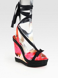 Blooming florals in berry hues transform this satin design ,with a strong espadrille wedge and solid ribbon ties. Satin-covered wedge, 5½ (140mm)Covered platform, 1½ (40mm)Compares to a 4 heel (100mm)Satin upper with grosgrain ribbon trimSatin liningSignature red leather solePadded insoleMade in Spain