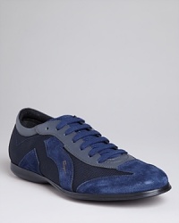 Elevate your casual look with these two-toned slim sneakers from Salvatore Ferragamo, embellished with suede and leather panels. Elevate your casual look with these two-toned slim sneakers from Salvatore Ferragamo, embellished with suede and leather panels.