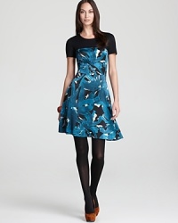 Embrace a bold vision of femininity in a flared DKNY dress blooming with strikingly oversized florals and accented with a contrast yoke for a thoroughly modern look. Embrace a bold vision of femininity in a flared DKNY dress blooming with strikingly oversized florals and accented with a contrast yoke for a thoroughly modern look.
