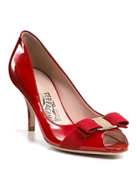 Slick and shining, these sleek pumps are the epitome of Italian-style chic. A grosgrain bow, finished with a Salvatore Ferragamo logo plate, wraps the peeptoe. Slick and shining, these sleek pumps are the epitome of Italian-style chic. A grosgrain bow, finished with a Salvatore Ferragamo logo plate, wraps the peeptoe.