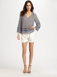 Sprinkled in a dainty floral print, this airy silk top has a drawstring v-neck and long, billowy sleeves. Drawstring v-neckLong sleevesSilkDry cleanImportedModel shown is 5'10 (177cm) wearing US size Small.
