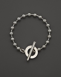 A bold toggle closure finishes this sterling silver circle bracelet.