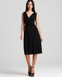 From day to night, you're fashioned for greatness in this Burberry London LBD designed with tailored pleats, a defined waistline and a crossover neckline for a hint of decolletage. An exposed back zip finishes the style with modernity.