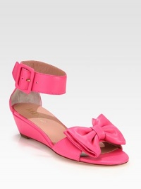A large bows rests on this butter-soft leather silhouette, with a comfortable demi-wedge and adjustable ankle strap. Self-covered wedge, 1¾ (45mm)Leather upperAdjustable ankle strapLeather lining and solePadded insoleMade in Italy A large bows rests on this butter-soft leather silhouette, with a comfortable demi-wedge and adjustable ankle strap. Self-covered wedge, 1¾ (45mm)Leather upperAdjustable ankle strapLeather lining and solePadded insoleMade in Italy