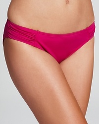Do the bright thing with this solid swimsuit from Tommy Bahama. A hipster cut and shirred side detailing ensure this piece is as flattering as it is stylish.