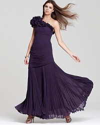 This Mignon one-shoulder gown is articulated in intricate accordion pleats and flourished with origami-like rosettes at the neckline, adding dimension and drama. This Mignon one-shoulder gown is articulated in intricate accordion pleats and flourished with origami-like rosettes at the neckline, adding dimension and drama.