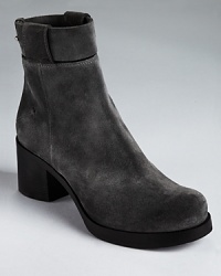 CoSTUME NATIONAL stays ahead of the curve with the Ziggy ankle boots--a fashion-forward style showcasing a runway-worthy look in a thick, chunky silhouette. CoSTUME NATIONAL stays ahead of the curve with the Ziggy ankle boots--a fashion-forward style showcasing a runway-worthy look in a thick, chunky silhouette.