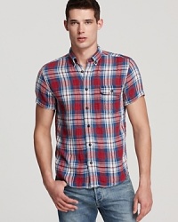 Brighten up your day with this classic plaid sport shirt that's festooned with color and rendered in soft cotton for an authentic look and feel. Brighten up your day with this classic plaid sport shirt that's festooned with color and rendered in soft cotton for an authentic look and feel.