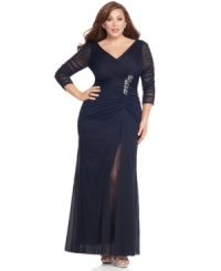 This plus size evening gown by Adrianna Papell sparkles in the spotlight of a special occasion with flattering ruching and jeweled detailing. This plus size evening gown by Adrianna Papell sparkles in the spotlight of a special occasion with flattering ruching and jeweled detailing.