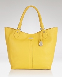 Brighten up your purse portfolio with Cole Haan's leather tote bag. In a crave-worthy hue and classic shape, this bag strikes an enviable balance between trendy and timeless. Brighten up your purse portfolio with Cole Haan's leather tote bag. In a crave-worthy hue and classic shape, this bag strikes an enviable balance between trendy and timeless.