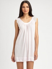 Eyelet cap sleeves with scallop trim make for a truly feminine design, with a wide scoop neckline and front shirring for added drape. Scoopneck with shiny trimEyelet cap sleeves with scallop edgesFront shirringShiny banded hemAbout 34 from shoulder to hem65% polyester/35% rayonMachine washImported Eyelet cap sleeves with scallop trim make for a truly feminine design, with a wide scoop neckline and front shirring for added drape. Scoopneck with shiny trimEyelet cap sleeves with scallop edgesFront shirringShiny banded hemAbout 34 from shoulder to hem65% polyester/35% rayonMachine washImported