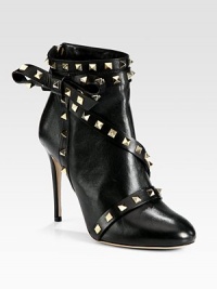 Balance masculine and feminine wearing this on-trend leather ankle boot, topped with edgy metal studs and a dimensional side bow. Self-covered heel, 4¼ (110mm)Leather upper with metal studsBack zipLeather lining and solePadded insoleMade in Italy Balance masculine and feminine wearing this on-trend leather ankle boot, topped with edgy metal studs and a dimensional side bow. Self-covered heel, 4¼ (110mm)Leather upper with metal studsBack zipLeather lining and solePadded insoleMade in Italy
