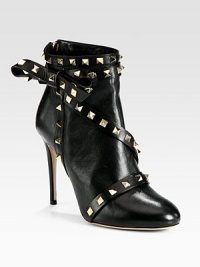 Balance masculine and feminine wearing this on-trend leather ankle boot, topped with edgy metal studs and a dimensional side bow. Self-covered heel, 4¼ (110mm)Leather upper with metal studsBack zipLeather lining and solePadded insoleMade in Italy