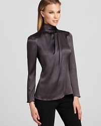 Rendered in lush stretch silk, this Armani Collezioni turtleneck blouse elevates workday style with effortless chic. Bring staple LBPs and pencil skirts from basic to beautiful with these elegant addition. Rendered in lush stretch silk, this Armani Collezioni turtleneck blouse elevates workday style with effortless chic. Bring staple LBPs and pencil skirts from basic to beautiful with these elegant addition.