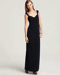 Classic elegance with a twist. Amsale's floor-grazing gown features a demure cap-sleeved silhouette with a thin halter strap around the neck. Classic elegance with a twist. Amsale's floor-grazing gown features a demure cap-sleeved silhouette with a thin halter strap around the neck.