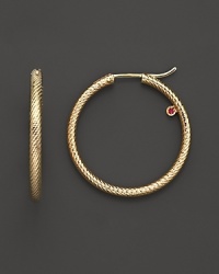 18K yellow gold hoop earrings with signature ruby accent from Roberto Coin. 18K yellow gold hoop earrings with signature ruby accent from Roberto Coin.