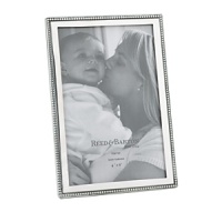 The Baby Beads 4 x 6 Picture Frame from Reed & Barton offers a wonderful way to display your favorite photo of the little one in your life. It features beads of lustrous non-tarnish bright pewter along the edge of the frame, making this perfect for display in your home or as a wonderful gift.