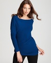 Elie Tahari's long, tunic length sweater lends a flattering look when teamed with skinny black pants.