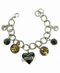 For the wild at heart, this charm bracelet from GUESS is crafted from silver-tone mixed metal with jet and glass crystal accents bringing a stylish edge. Leopard print enhances the animal attraction. Item comes packaged in a signature GUESS Gift Box. Approximate length: 7-1/2 inches. Approximate drop: 1 inch. Approximate diameter: 1-1/2 inches. For the wild at heart, this charm bracelet from GUESS is crafted from silver-tone mixed metal with jet and glass crystal accents bringing a stylish edge. Leopard print enhances the animal attraction. Item comes packaged in a signature GUESS Gift Box. Approximate length: 7-1/2 inches. Approximate drop: 1 inch. Approximate diameter: 1-1/2 inches.