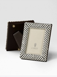 Intricate braid design, in gleaming platinum tone, adds dimension to a favorite photo.Classic beveled glassStretched leather backingGift boxedImported Intricate braid design, in gleaming platinum tone, adds dimension to a favorite photo.Classic beveled glassStretched leather backingGift boxedImported