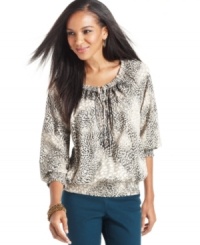 Style&co. puts a wild spin on a peasant top with this bold animal-inspired print.