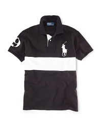 A short-sleeved polo shirt is cut for a trim, athletic-looking fit from durable cotton mesh with a bold stripe at the chest for a cool, color-blocked style. A short-sleeved polo shirt is cut for a trim, athletic-looking fit from durable cotton mesh with a bold stripe at the chest for a cool, color-blocked style.