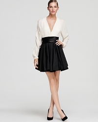 Halston Heritage gets classic with this timeless black and white creation, perfectly modernized with a plunging v-neck and dramatic back slit. Halston Heritage gets classic with this timeless black and white creation, perfectly modernized with a plunging v-neck and dramatic back slit.