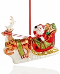 And away they go! Santa Claus takes to the sky with a fully loaded sleigh in this joyful glass ornament for trimming a classic holiday tree. And away they go! Santa Claus takes to the sky with a fully loaded sleigh in this joyful glass ornament for trimming a classic holiday tree.