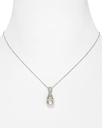 A strand of shimmering simulated pearls takes on a new state of grace on this Nadri necklace, accented by an ornate crystal-bedecked pendant. A strand of shimmering simulated pearls takes on a new state of grace on this Nadri necklace, accented by an ornate crystal-bedecked pendant.