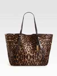 A chic haircalf style in an exotic animal print accented with smooth leather trim.Double adjustable leather top handles, 8¾-9½ dropMagnetic snap closureOne inside zip pocketTwo inside open pocketsSuede lining14W X 12H X 7DImported A chic haircalf style in an exotic animal print accented with smooth leather trim.Double adjustable leather top handles, 8¾-9½ dropMagnetic snap closureOne inside zip pocketTwo inside open pocketsSuede lining14W X 12H X 7DImported