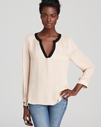 A neutral palette sets the scene for chic with this Joie top in lightweight silk with elegant black trim. A neutral palette sets the scene for chic with this Joie top in lightweight silk with elegant black trim.