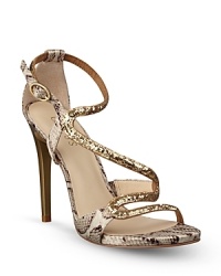 Channel your inner Cleopatra in these sensual, strappy sandals, mixing golden and snake-embossed leather for a timelessly regal effect; by GUESS. Channel your inner Cleopatra in these sensual, strappy sandals, mixing golden and snake-embossed leather for a timelessly regal effect; by GUESS.
