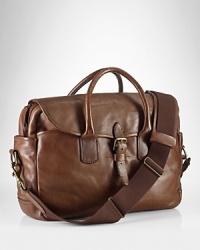 Drawing rustic inspiration from days spent in the great outdoors, a handsome bag is rendered in rich leather with antiqued brass accents for an authentic, timeworn look. Drawing rustic inspiration from days spent in the great outdoors, a handsome bag is rendered in rich leather with antiqued brass accents for an authentic, timeworn look.