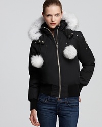 Flaunting playful fox fur pom poms and a plush ruff, this Moose Knuckles bomber jacket ensures cozy winter weekends--in the city or on the slopes. Flaunting playful fox fur pom poms and a plush ruff, this Moose Knuckles bomber jacket ensures cozy winter weekends--in the city or on the slopes.