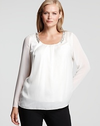 An intricately beaded neckline glams up the classic DKNYC Plus shirt, finished with sheer sleeves for a dose of provocative edge. An intricately beaded neckline glams up the classic DKNYC Plus shirt, finished with sheer sleeves for a dose of provocative edge.