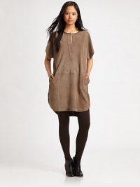 Tribal-chic tunic of velvety goat suede has dropped shoulders, short dolman sleeves and slash pockets. Crewneck with button closureDropped shouldersShort dolman sleevesSlash pocketsLonger length hits below the hipsGoat suedeDry clean with leather specialistImportedModel shown is 5'10 (177cm) wearing US size Small. Tribal-chic tunic of velvety goat suede has dropped shoulders, short dolman sleeves and slash pockets. Crewneck with button closureDropped shouldersShort dolman sleevesSlash pocketsLonger length hits below the hipsGoat suedeDry clean with leather specialistImportedModel shown is 5'10 (177cm) wearing US size Small.