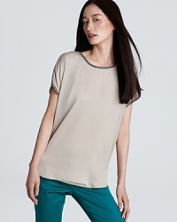 Intricate beading and sheer styling lend a delicate finish to a nude DKNYC top. Team with sleek denim and metallic accents for effortless elegance. Intricate beading and sheer styling lend a delicate finish to a nude DKNYC top. Team with sleek denim and metallic accents for effortless elegance.
